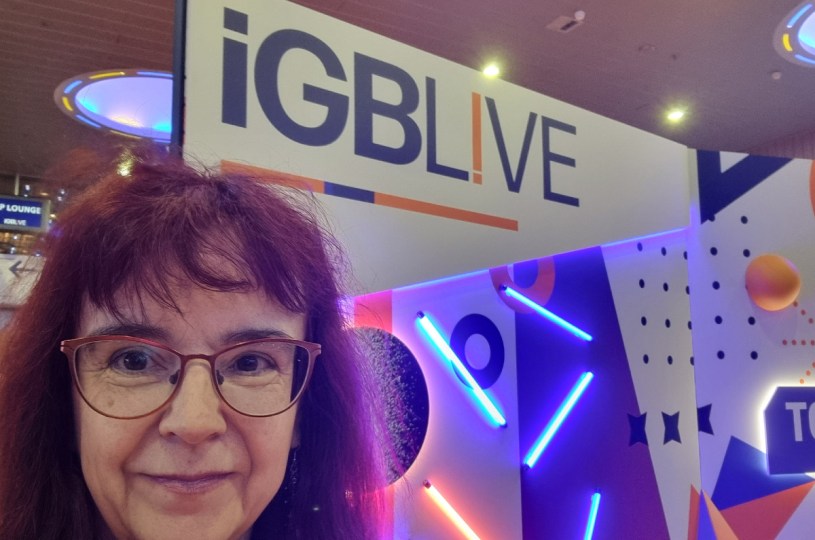Sue Dawson of FTD Digital in front of a large iGB Live sign